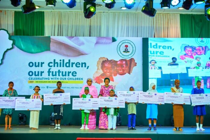 CHILDREN’S DAY1 (in the middle) Wife of Vice President Hajia Nana Shettima, First Lady of Nigeria Senator Oluremi Tinubu with representatives of the schools that participated at the special event tagged Celebrating with Our Children with the theme, Our Children, Our Future after being presented with N10m cheques for their schools. The event was held in commemoration of the 1st anniversary of President Bola Tinubu Administration on Monday 27th May 2024