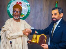 Minister of Environment, Balarabe Abbas Lawal receiving a plaque from the United Arab Emirates (UAE), to Nigeria, H. E Salem Saeed when the Ambassador paid a working visit to the Federal Ministry of Environment, Mabushi Abuja
