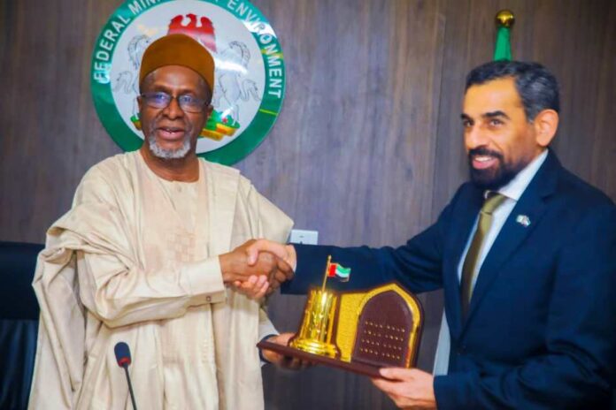 Minister of Environment, Balarabe Abbas Lawal receiving a plaque from the United Arab Emirates (UAE), to Nigeria, H. E Salem Saeed when the Ambassador paid a working visit to the Federal Ministry of Environment, Mabushi Abuja
