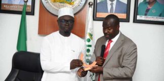 Leader of Delegation , African-Arab Youth Council, Dr Abbas Agaba Mugisha (right) presenting a plaque to the Hon. Minister of State for Youth Development, Ayodele Olawande during their courtesy call on the Minister.