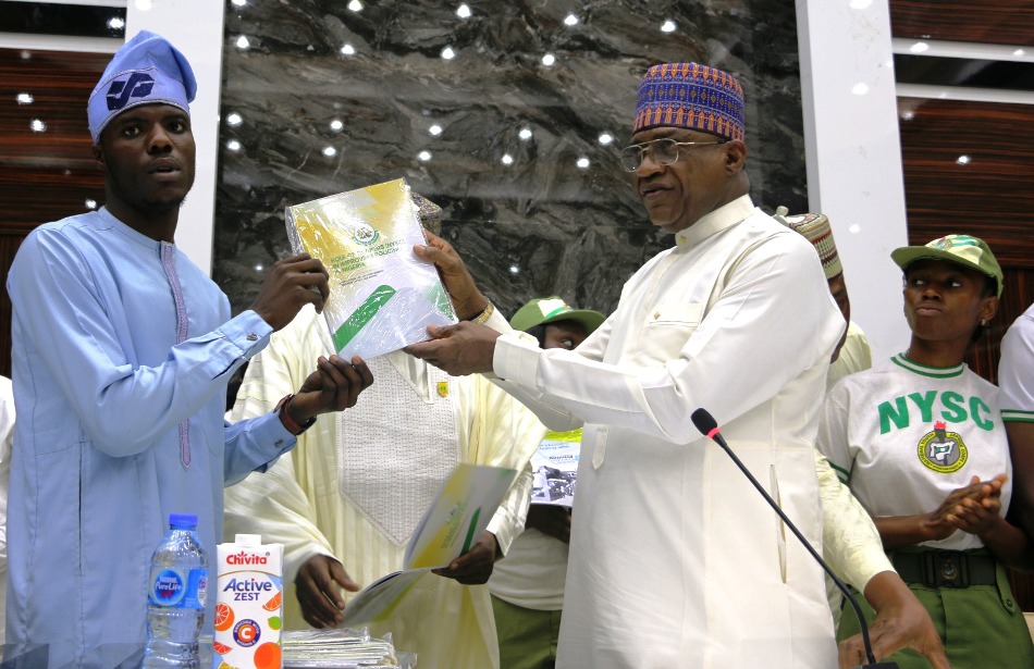 L-R: Pcorp Member, Agunbiade Abdulqudus and Minister of Police Affairs, Senator Ibrahim Gaidam; during the presentation of a report on the Role of Corpers (NYSC) in improving policing in Nigeria held at the Education conference room, Federal Secretariat, Abuja