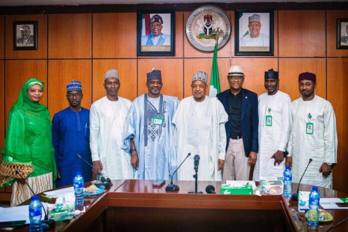 The Hon. Minister of Budget and Economic Planning Sen. Abubakar A. Bagudu, the Permanent Secretary FMBEP to his right, the Kaduna State Commissioner for Planning and Budget Commission Hon. Muktar Ahmed left, of the Minister flanked by senior management staff of the State Commission in the Minister's office yesterday.