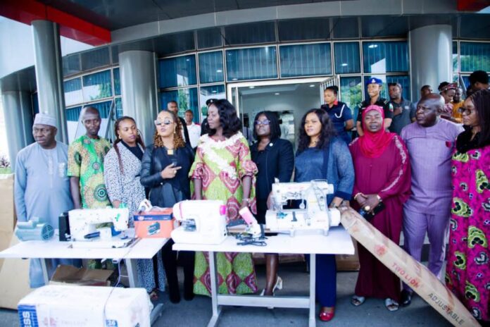 empowerment machines for distribution 4th from left - Honourable Minister of Women Affairs, Barrister (Mrs) Kennedy-Ohanenye, House of Representatives member representing Langtang North and South Constituency, Beni Lar; Director, Women Development Department, Federal Ministry of Women Affairs, Mrs Funke Oladipo and other dignitaries with some of the empowerment machines for distribution to various States of the Federation