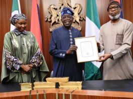 Minister of Solid Minerals Development, Dr. Dele Alake presenting the gold bar document to President Bola Tinubu at the State House, Abuja recently. With them is the Executive Secretary, Solid Minerals Development Fund, Mrs Fatimah Shinkafi.