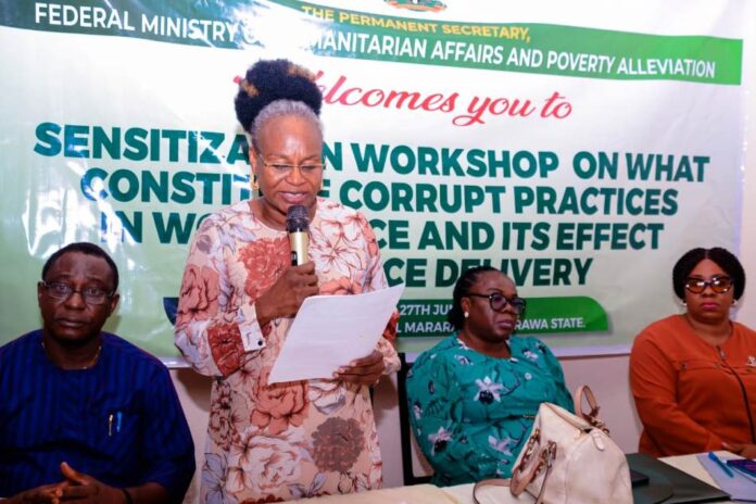 Humanitarian Ministry Trains Servicom Desk Officers 1 (Standing) Representative of the Permanent Secretary Federal Ministry of Humanitarian Affairs and Poverty Alleviation, the Director, Planning, Research and Statistics, Patienc N. Oyekunle, delivering a keynote address at the sensitization workshop on What Constitute Corruption in the Work Place, organized for Ministry's SERVICOM Desk Officers, held in Mararaba, Nasarawa State