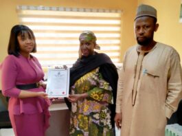 Ag. Executive Director, NIWRMC, Hajiya Sakinatu Abbo Jimeta(M) presenting the Water Use Licence to Pamela Gold, the Senior Manager, Legal and Regulatory, Penstock Energy Ltd (L), flanked by the Director, Allocation and Authorization, Engr. Shazali Uba Ajingi (R) in NIWRMC, Abuja