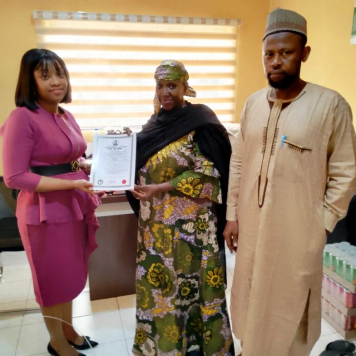 FG Grants Water Use Licences To BUA Cement And Penstock Energy Ltd2 Ag. Executive Director, NIWRMC, Hajiya Sakinatu Abbo Jimeta(M) presenting the Water Use Licence to Pamela Gold, the Senior Manager, Legal and Regulatory, Penstock Energy Ltd (L), flanked by the Director, Allocation and Authorization, Engr. Shazali Uba Ajingi (R) in NIWRMC, Abuja