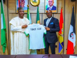 The Honourable Minister of Interior, Hon. (Dr.) Olubunmi Tunji-Ojo (R) receiving a customized jersey from the President, NFF, Alhaji Ibrahim Musa Gusau.(L).