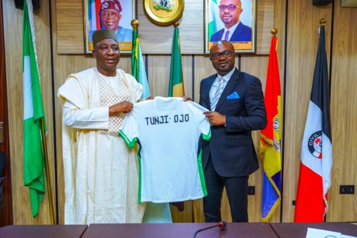 Gender Inclusiveness In Football1 The Honourable Minister of Interior, Hon. (Dr.) Olubunmi Tunji-Ojo (R) receiving a customized jersey from the President, NFF, Alhaji Ibrahim Musa Gusau.(L).