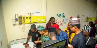 2nd left - Honourable Minister of Women Affairs, Barrister (Mrs) Uju Kennedy-Ohanenye cheering up a little child on admission after making a donation on behalf of the Ministry to his treatment at the National Hospital, Abuja