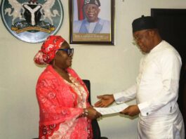 Perm Sec EPO, Dr. Aishetu Gogo Ndayako Mohammed receiving Handover- Notes from the Director, Pollution Control, Mr Clinton Igwe