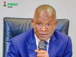 Hon minister of sports Development, John. Owan Enoh