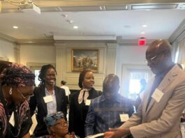 The Hon Minister of Education Prof Tahir Mamman receiving a book from the Director General World Trade Organisation ,Dr Ngozi Okonj-Iwela