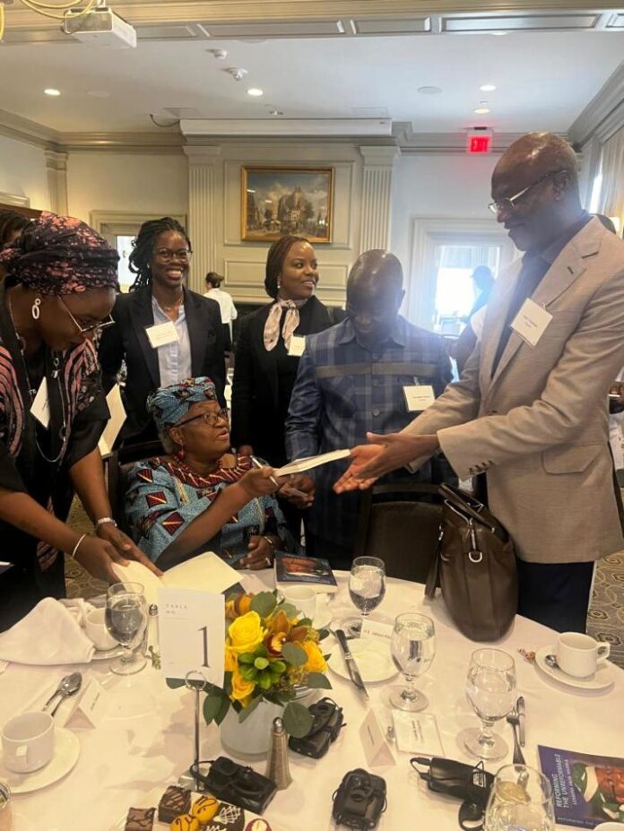 Education Minister on panel discussion The Hon Minister of Education Prof Tahir Mamman receiving a book from the Director General World Trade Organisation ,Dr Ngozi Okonj-Iwela