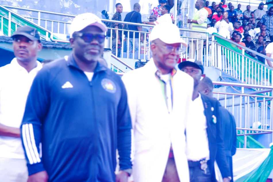 From R- L. The Honourable Minister of Sports Development, Sen. John Owan Enoh and the Governor of Delta State; RT Hon. (Elder) Sheriff Oborevwori during the match past by all the 36 States and FCT