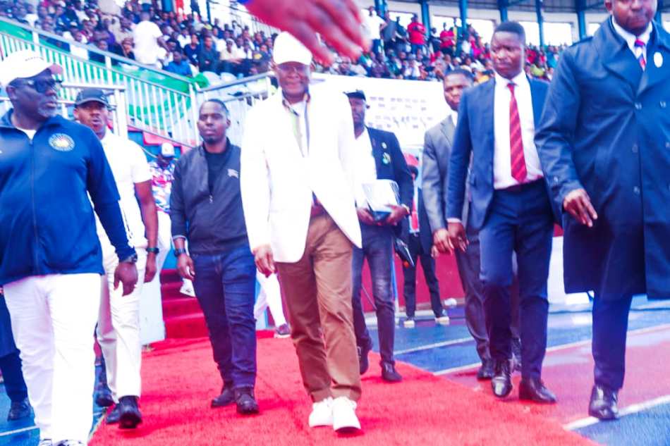 From R- L. The Honourable Minister of Sports Development, Sen. John Owan Enoh and the Governor of Delta State; RT Hon. (Elder) Sheriff Oborevwori during the match past by all the 36 States and FCT