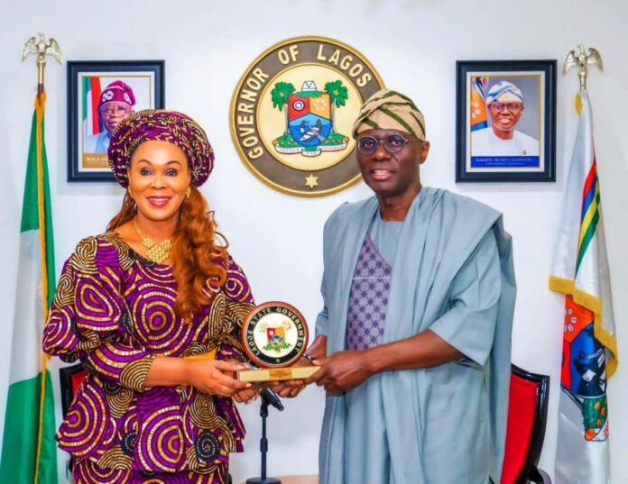 Federal Ministry Of Women Affairs Partners Lagos State Honourable Minister of Women Affairs Barrister (Mrs) Uju Kennedy-Ohanenye receiving a Souvenir from the Lagos State Governor, His Excellency, Babajide Sanwo-Olu during the visit