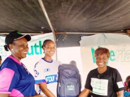 R- L: The Project Manager, Anti-Doping for the National Youth Games and the Chief Executive Officer NADC, Ms. Fadeke Fadeyibi, in a handshake with the Pricer Winner,; Jenifer Ehioziobue of Delta State and NADC Official