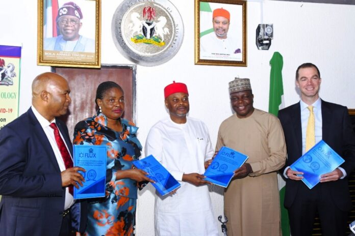 Nnaji Minister of Innovation, Science and Technology, Chief Uche Geoffrey Nnaji (middle), Permanent Secretary of the Ministry, Mrs. Esuabana Nko Asanye (2nd left) Director, Legal Services Department FMIST, Mr. Tanko Ashang SAN, (left) Director-General, National Biotechnology Research and Development Agency Prof. Mustapha Abdullahi (2nd right) and Chief Executive Officer Flux, Mr. Sam Davies (right) during the display of the Signed Memorandum of Understanding (MoU) Between the Ministry and Flux Carbon, today in Abuja.
