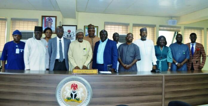 Front row,(Middle) Representative of RMAFC Chairman, Engr. Muhammed Sanni Baba, 2nd right, Dr. Abayomi Taofik Alaga, and others in a group photograph.