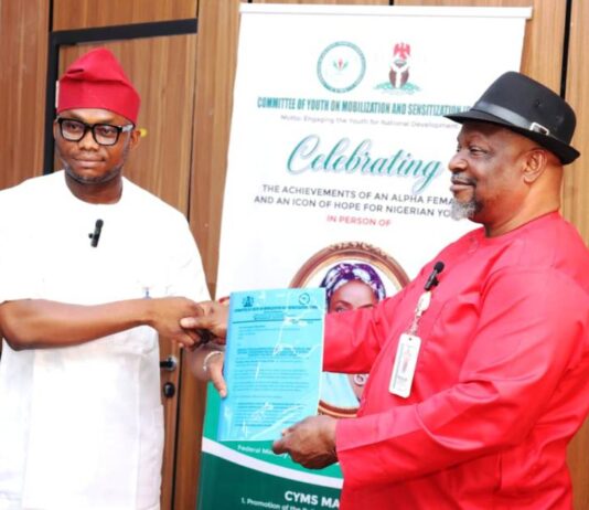 Director General, Committee on Youth Moblization and Sensitization, Obinna Nwaka (l), presents proposal collaboration with Federal Ministry of Special Duties and Inter-governmental Affairs to Director, Policy Implementation and Monitoring of Government Decisions, Dr. Cyprian Kpakol, rep. of the PS.