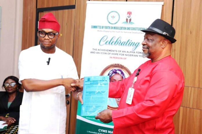 Special Duty Ministry To Partner CYMS Director General, Committee on Youth Moblization and Sensitization, Obinna Nwaka (l), presents proposal collaboration with Federal Ministry of Special Duties and Inter-governmental Affairs to Director, Policy Implementation and Monitoring of Government Decisions, Dr. Cyprian Kpakol, rep. of the PS.
