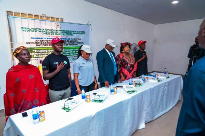 2024 Poverty Eradication Day 03 Members of the high table at the event (1st Right) Deputy Director overseeing the Office of the Director Social Development, FMHAPA Peter Audu , 2nd Right, SSA to the President on Humanitarian Affairs and Poverty Alleviation Hon. Delu Bulus Yakubu, Rep. Of the Permanent Secretary of the Ministry Odii Ndubuisi Barry, National Secretary Solidarity Empowerment Club Precious Jeje, Program Director Solidarity Empowerment Club and Woman leader, Karu Community