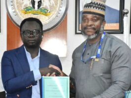 Minister of State for Youth Development, Comrade Ayodele Olawande (L), with the Country Director, Plan International, Mr Charles Usie, during the signing of an MoU between the Ministry and Plan International at the Minister of State office in Abuja on Thursday (10/10/24).
