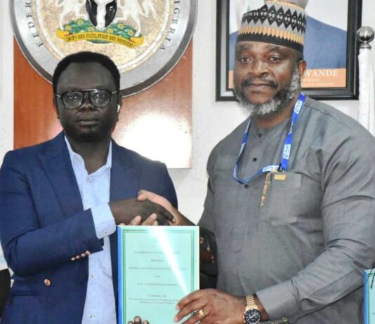 Minister of State for Youth Development, Comrade Ayodele Olawande (L), with the Country Director, Plan International, Mr Charles Usie, during the signing of an MoU between the Ministry and Plan International at the Minister of State office in Abuja on Thursday (10/10/24).