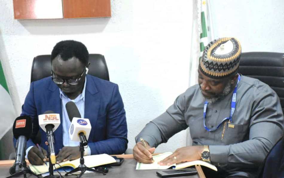 Minister of State for Youth Development, Comrade Ayodele Olawande (L), and the Country Director, Plan International, Mr Charles Usie, during the signing of an MoU between the Ministry and Plan International at the Minister of State office in Abuja on Thursday (10/10/24).