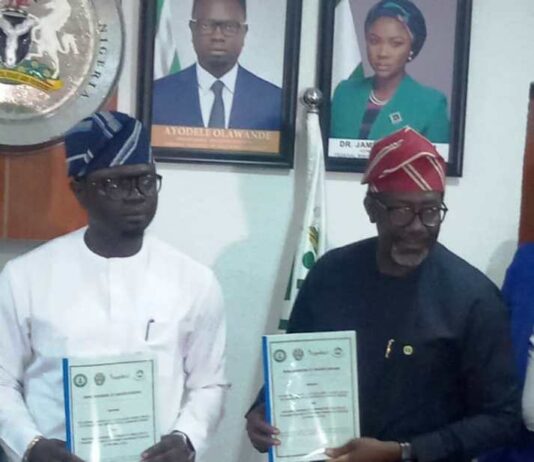 Left- right :The Honourable Minister of State, Federal Ministry of Youth Development, Comrade Ayodele Olawande and the Chief Executive, NAICOM, Olusegun Ayo Omosehin, displaying the signed MoU document in Abuja.