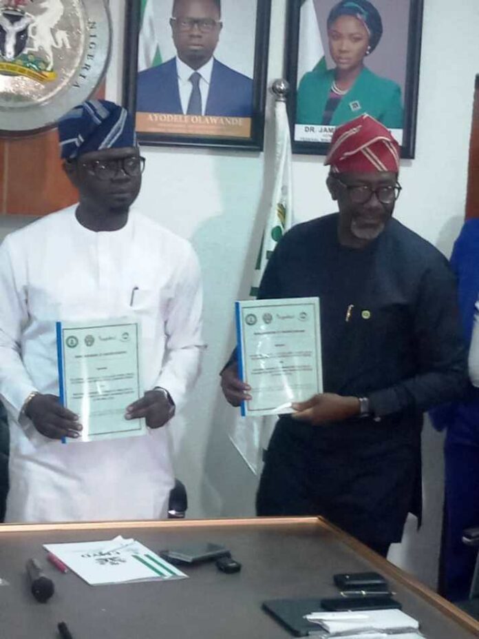 FG to Work with Stakeholders Left- right :The Honourable Minister of State, Federal Ministry of Youth Development, Comrade Ayodele Olawande and the Chief Executive, NAICOM, Olusegun Ayo Omosehin, displaying the signed MoU document in Abuja.