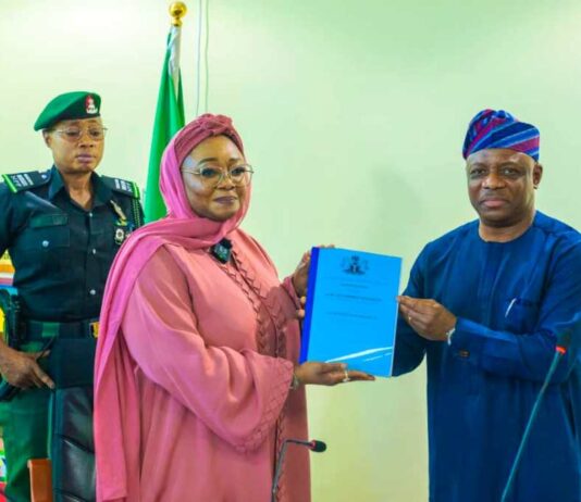 Honourable Minister of Women Affairs, Hajiya Imaan Sulaiman-Ibrahim, fsi, receiving the Hand-Over Notes from Ambassador Gabriel Aduda, the Ministry's Permanent Secretary today, in Abuja