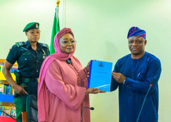 Imaan Sulaiman-Ibrahim 4 Honourable Minister of Women Affairs, Hajiya Imaan Sulaiman-Ibrahim, fsi, receiving the Hand-Over Notes from Ambassador Gabriel Aduda, the Ministry's Permanent Secretary today, in Abuja