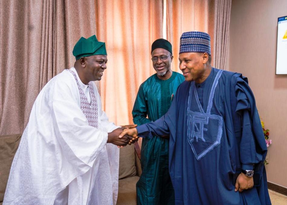 Honourable Minister of Water Resources and Sanitation, Engr. Prof. Joseph Terlumun Utsev,in a handshake with the Honourable Minister of Information and National Orientation, Muhammed Idris, while the Honourable Minister of Environment, Balarabe Abbas Lawal looks on.