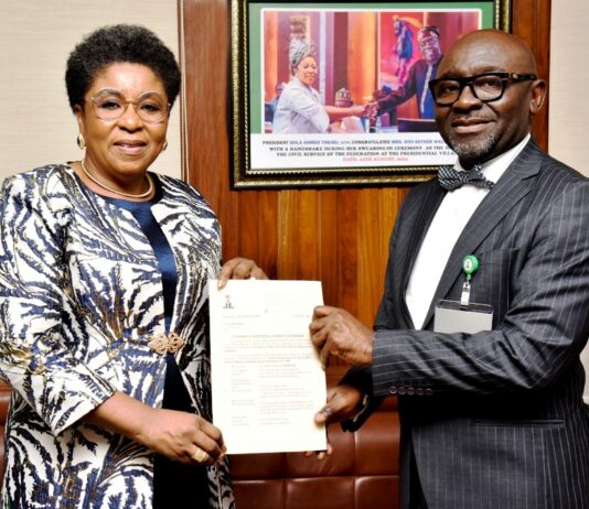 R-L: Mr Alfred Agaba Abah presenting his Letter of Appointment as SSAP to the Head of the Civil Service of the Federation, Mrs Didi Esther Walson-Jack, OON, mni.