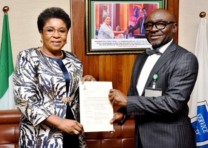 Mrs. Didi Esther Walson-Jack, OON, mni, and Mr. Alfred Agaba Abah R-L: Mr Alfred Agaba Abah presenting his Letter of Appointment as SSAP to the Head of the Civil Service of the Federation, Mrs Didi Esther Walson-Jack, OON, mni.