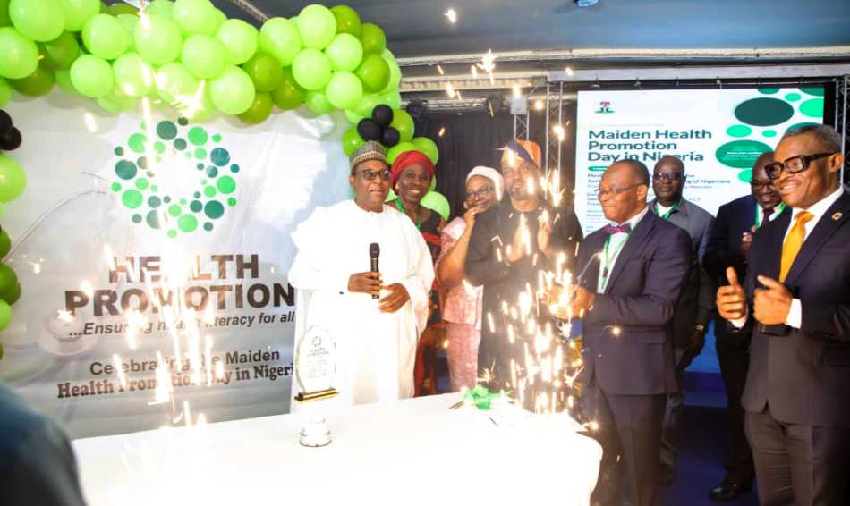 Logo of the Health Promotion unveiled by the Honourable Coordinating Minister Prof Muhammad Ali Pate, assisted by the Permanent Secretary, represented by Dr. Olubunmi Aribeana Director Food & Drugs Department; Dr. Binyerem Ukaire Director Family Health Department; Representative of 36 Health State Commissioners Dr. Banji Filani ( Ekiti State Health Commissioner); Dr. Ejike Orji, Chairman Local Organising Committee and, Dr. Anyaike, Director Public Health Department of the Ministry.