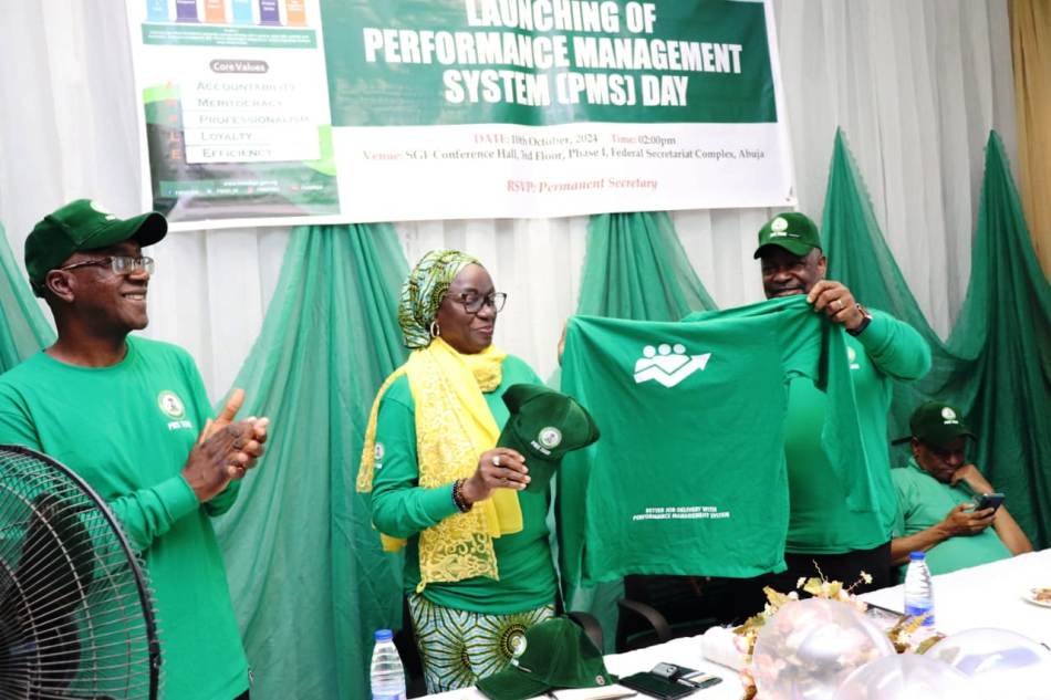 Official presentation of the PMS regalia to Permanent Secretary, Federal Ministry of Special Duties and Inter-governmental Affairs, Dr. Maryam Ismaila Keshinro (m) by Director, Policy Implementation and Monitoring of Government Decisions, Dr. Cyprian Kpakol while Director, PS Office, Dr. Abdul Garba looks on.