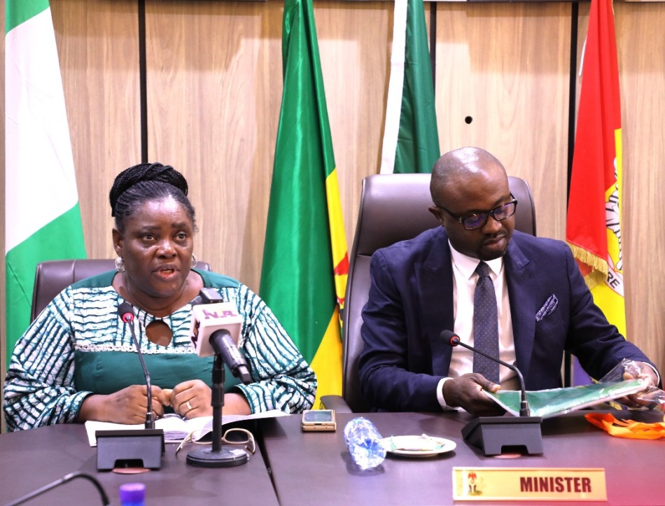 Committee Secretary investigating alleged malfeasance in Custodian facility, Dr. Uju Agomoh, reading the first phase of its report to the Hon Minister of Interior, Dr. Olubunmi Tunji-Ojo
