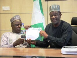ES NCPWD, Chief Ayuba Gufwan with the MD NELFUND Mr. Akintunde Sawyerr.