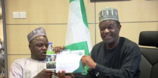 ES NCPWD, Chief Ayuba Gufwan with the MD NELFUND Mr. Akintunde Sawyerr.