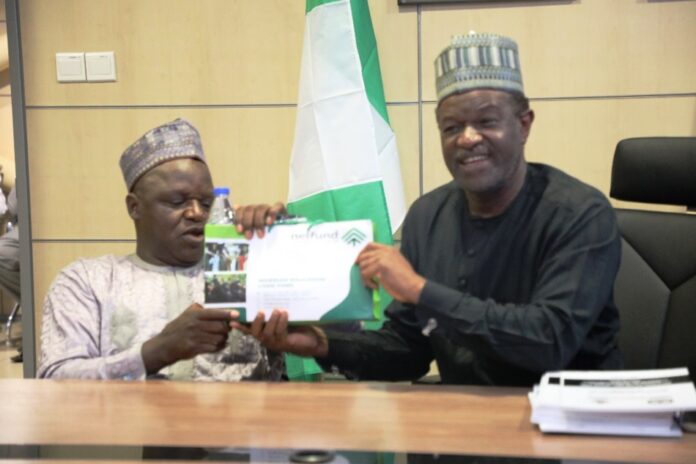 ES NCPWD, Chief Ayuba Gufwan with the MD NELFUND Mr. Akintunde Sawyerr.