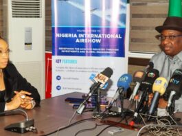 L-R: Chief Executive Officer of Nigeria International Airshow, Bria Williams listening to the Hon. Minister while delivering his Address at the event.