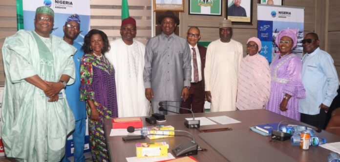 IMG-20241109-WA0010 Hon, Minister, Ministry of Aviation and Aerospace Development and the Permanent Secretary in a group photograph. with retired Directors of the Ministry