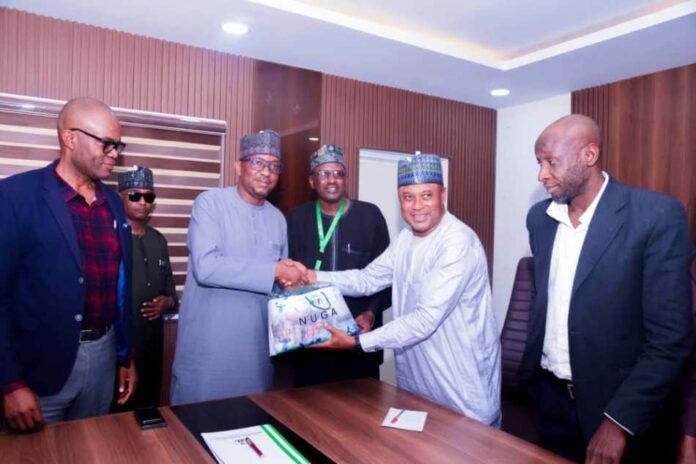 The President of Nigeria Universities Games Association (NUGA) Dr. Bawa Muhammed presenting souvenir to the Chairman of Nigeria Sports Commission, Mallam Shehu Dikko, during the Association's courtesy visit to the Chairman in his office recently in Abuja.