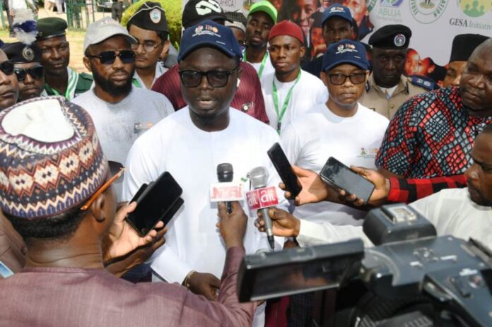 Minister of Youth Development, Comrade Olawande Ayodele (M), addressing the press during the commemoration of the Africa and National Youth Day celebration in Abuja on Friday (1/11/24). With him is the Permanent Secretary, Federal Ministry of Youth Development, Mr Olubunmi Olusanya (R).