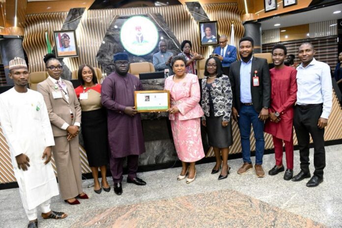 Online Compendium Of Circulars2 Head of the Civil Service of the Federation, Mrs. Didi Esther Walson-Jack, OON, mni, pose with the symbolic certificate of the Online Compendium of Circulars with members of the technical team.