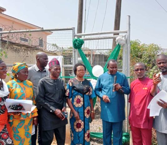 3rd Left, Representative of Prof. Nentawe Goshwe Yilwatda, Honourable Minister of Humanitarian Affairs and Poverty Reduction, the Director General Services, of the Ministry, Mr. Yakubu A. John, 3rd left, Deputy Director Overseeing the Office of the Director, Social Development, of the Ministry Mr. Peter Adanu Audu, Representative of Dr. Barr. Ndubueze Mbah, Hon. Commissioner for Education, Enugu State, Mrs. Ifeoma B. OnuIgbo (Area Lead Evaluator), Enugu East (Ujodo), Overseeing Provost, Federal School of Social Work, Emene (FSSWE), Enugu, Mr. Chris Ajibola and 1st right, Mr. Oparaku Modestus ( represented Engr. osita in Obiukwu) from NEMSA, during the commissioning of 100KVA Transformer purchased by the Ministry for the School of Social Work Emene, Enugu State on Tuesday 10th December 2024