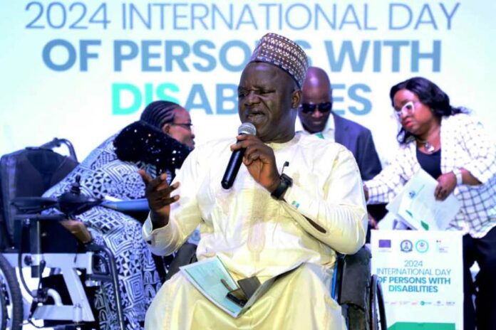 2024 International Day of Persons with Disabilities2 The Executive Secretary of the National Commission for Persons with Disabilities, Hon. Ayuba Gufwan, delivering the welcome address at the 2024 National Dialogue in commemoration of the International Day of Persons with Disabilities.